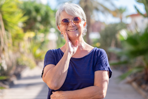 Life Assure Senior Woman Sitting In Chair And Laughing With Caregiver Nurse Blog